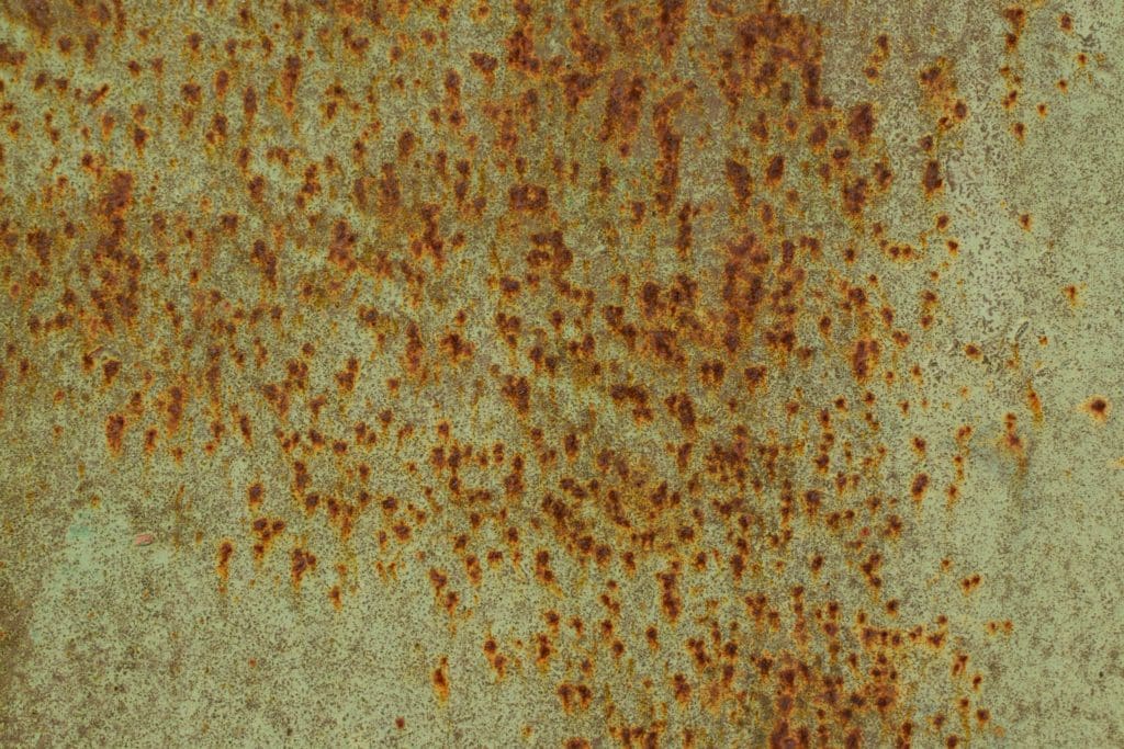 Green and rust colored pitting corrosion.